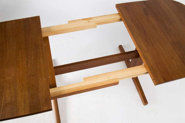 Solid teak dining table with 1 leaf.