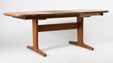 Solid teak dining table with 1 leaf.