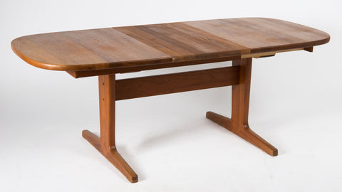 Solid teak dining table with 1 leaf.