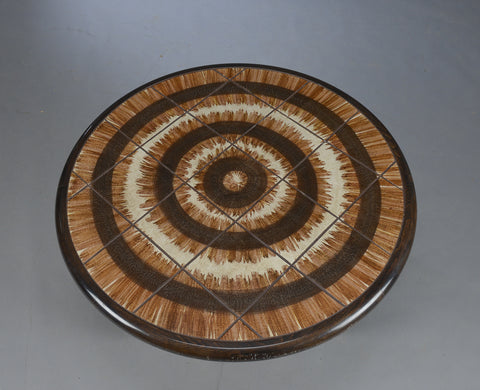Round oak coffee table with dark stain.