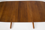 Solid teak dining table with 1 leaf.