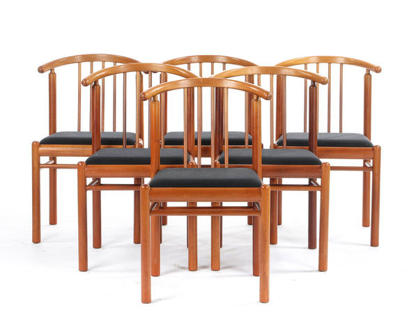 Solid Mahogany dining room table with two extension flaps and six matching chairs.