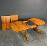 Solid Teak Dining table with 2 self storing extentions.