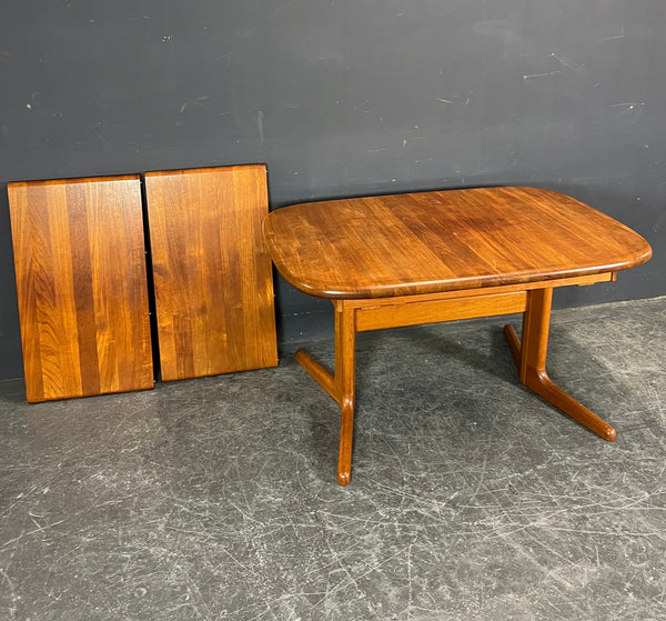 Solid Teak Dining table with 2 self storing extentions.