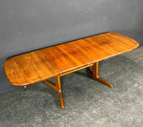 Solid Teak Dining table with 2 self storing extentions.