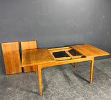 Solid teak table with two extension leaves. Produced by Niels Bach Denmark