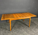 Solid teak table with two extension leaves. Produced by Niels Bach Denmark