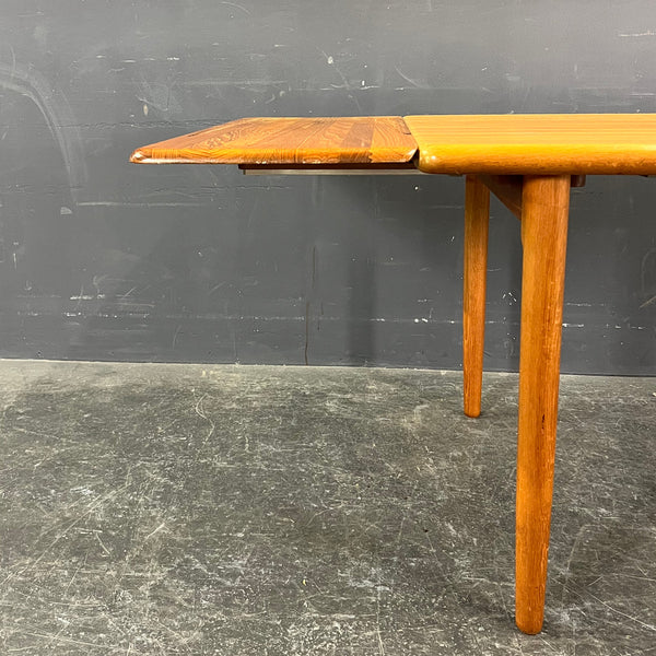 HIGHLY UNUSUAL RECTANGULAR SOLID TEAK EXTENDABLE DINING TABLE.