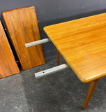 HIGHLY UNUSUAL RECTANGULAR SOLID TEAK EXTENDABLE DINING TABLE.