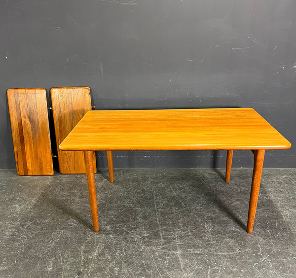 HIGHLY UNUSUAL RECTANGULAR SOLID TEAK EXTENDABLE DINING TABLE.