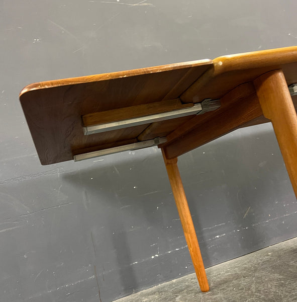 HIGHLY UNUSUAL RECTANGULAR SOLID TEAK EXTENDABLE DINING TABLE.