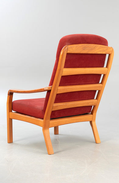 Sculptured Solid Teak armchair with matching stool.