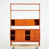 TEAK BOOKCASE. A mid-20th century, teak, two-piece, lower cabinet with drawers.