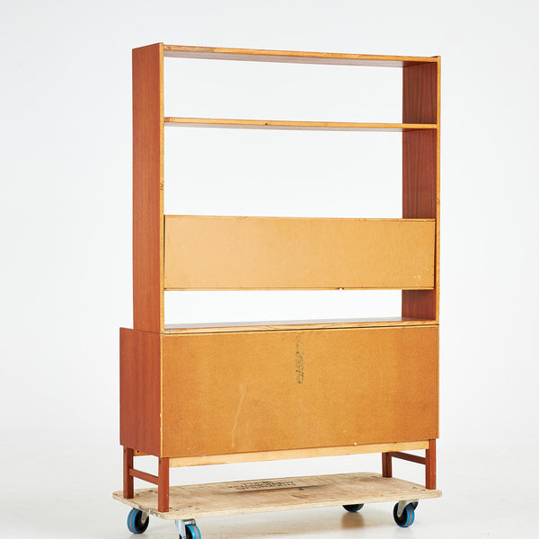 TEAK BOOKCASE. A mid-20th century, teak, two-piece, lower cabinet with drawers.