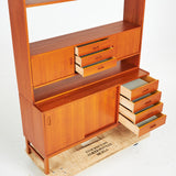 TEAK BOOKCASE. A mid-20th century, teak, two-piece, lower cabinet with drawers.