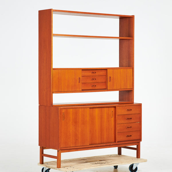 TEAK BOOKCASE. A mid-20th century, teak, two-piece, lower cabinet with drawers.
