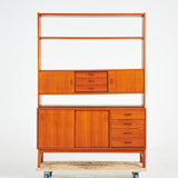 TEAK BOOKCASE. A mid-20th century, teak, two-piece, lower cabinet with drawers.