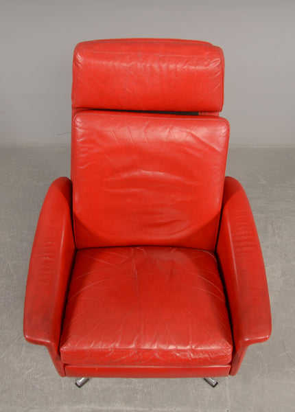Armchair on swivel base with red leather and stool