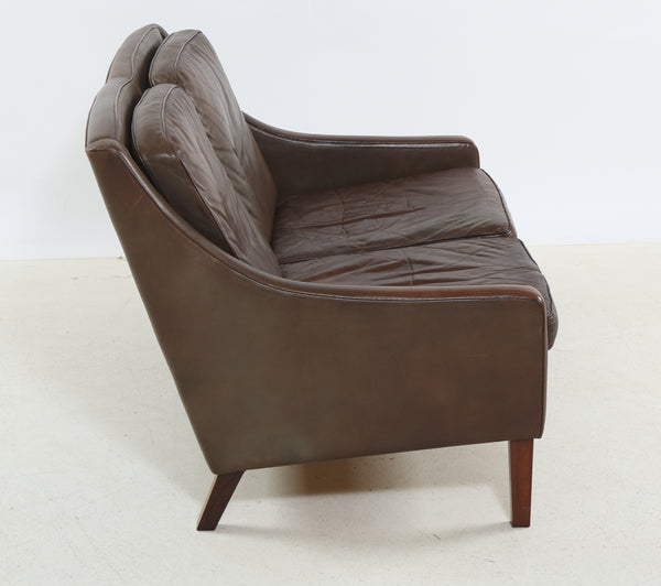Poul M. Volther Love seat upholstered in brown leather.
