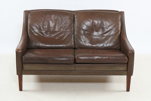 Poul M. Volther Love seat upholstered in brown leather.