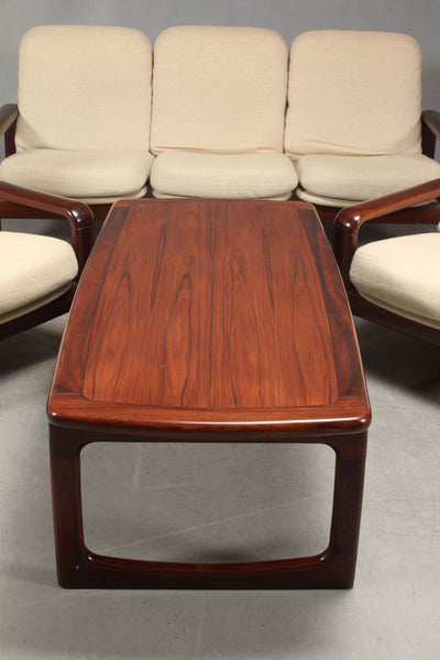 Rosewood coffee table with solid rose wood frame.