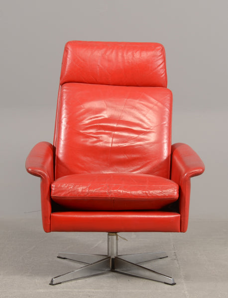 Armchair on swivel base with red leather and stool