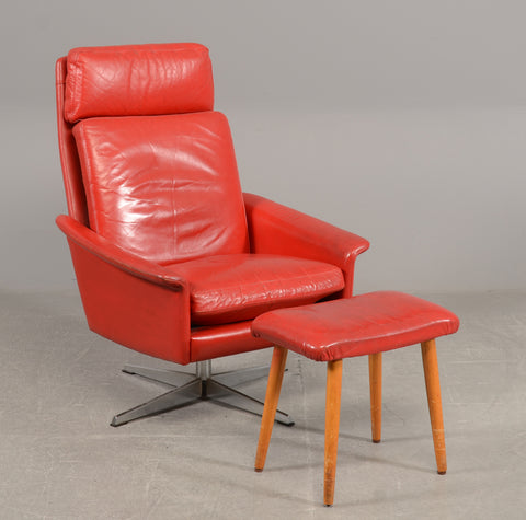 Armchair on swivel base with red leather and stool