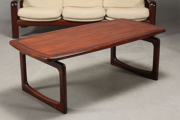 Rosewood coffee table with solid rose wood frame.