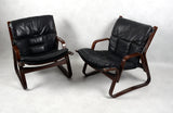 ARMCHAIRS, a pair of 1970s. Black leather, frame in dark stained bentwood