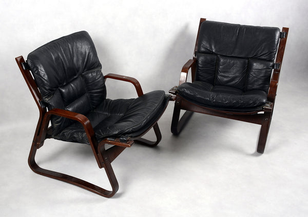 ARMCHAIRS, a pair of 1970s. Black leather, frame in dark stained bentwood